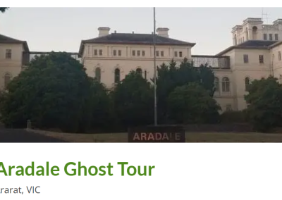View of the Aradale Ghost Tour location in Ararat, VIC, featuring the historic Aradale Asylum building, surrounded by lush greenery, with a sign indicating the tour entrance, creating an eerie yet intriguing atmosphere.