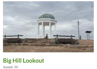 Big Hill Lookout in Stawell, VIC, showcasing a white stone pavilion with a dome on top, set against a cloudy sky. Visitors can be seen seated on stone steps, providing a panoramic view of the surrounding landscape